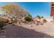 Spacious backyard featuring desert landscaping, a fire pit, and comfortable seating area at 80 S Maple Ct, Chandler, AZ 85226