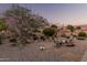 Backyard with seating around a fire pit, ambient lighting, and desert landscaping at 80 S Maple Ct, Chandler, AZ 85226