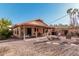 Expansive backyard showcasing a covered patio, dining area, fire pit, and desert landscaping at 80 S Maple Ct, Chandler, AZ 85226