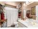 Cozy bathroom featuring a shower with curtain, vanity with mirror, and neutral earth tone color palette at 80 S Maple Ct, Chandler, AZ 85226