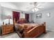 Cozy bedroom with ceiling fan, soft carpet, decorative bed, and natural light from window at 80 S Maple Ct, Chandler, AZ 85226