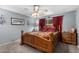 Comfortable bedroom with a ceiling fan, soft carpet, and a decorative wooden bed frame at 80 S Maple Ct, Chandler, AZ 85226