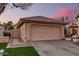 Beige single-story home with a garage, concrete driveway, desert landscaping and well-maintained lawn at 80 S Maple Ct, Chandler, AZ 85226