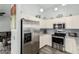 Bright kitchen featuring stainless steel refrigerator, ample counter space, and modern appliances at 80 S Maple Ct, Chandler, AZ 85226