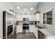 A well-equipped kitchen featuring stainless steel appliances, ample cabinets, and granite countertops at 80 S Maple Ct, Chandler, AZ 85226