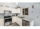 Well-lit kitchen with stainless steel appliances, ample counter space, and a window above the sink at 80 S Maple Ct, Chandler, AZ 85226