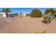 Wide angle shot of backyard with desert landscaping and native vegetation at 8233 E Calypso Ave, Mesa, AZ 85208