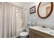 Bathroom with white tiled shower and tub, as well as a bright sink and mirror at 8233 E Calypso Ave, Mesa, AZ 85208