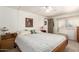 Comfortable bedroom featuring a ceiling fan, closet, dresser and natural light at 8233 E Calypso Ave, Mesa, AZ 85208