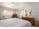 Bright bedroom with ceiling fan, carpet flooring,dresser and natural light at 8233 E Calypso Ave, Mesa, AZ 85208