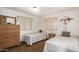 Cozy bedroom featuring twin beds, wood dresser, and bright natural lighting at 8233 E Calypso Ave, Mesa, AZ 85208