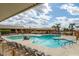 Large community pool with lounge chairs and seating, blue skies and palm trees in the background at 8233 E Calypso Ave, Mesa, AZ 85208