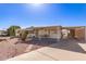 Cozy single-story home with well-kept yard and covered parking area at 8233 E Calypso Ave, Mesa, AZ 85208