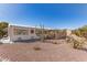 Single story home featuring desert landscaping and neutral-toned exterior at 8233 E Calypso Ave, Mesa, AZ 85208