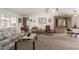 Comfortable living room with ceiling fan, neutral carpeting, and bright natural light at 8233 E Calypso Ave, Mesa, AZ 85208