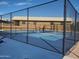 Blue pickle ball court with a fence and view of a building at 8233 E Calypso Ave, Mesa, AZ 85208