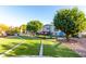 This backyard features a swing, seating area, and mature landscaping at 8258 E Calypso Ave, Mesa, AZ 85208