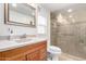 Bathroom featuring a walk-in shower, vanity with wood cabinets, and tiled floors at 8258 E Calypso Ave, Mesa, AZ 85208