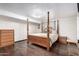 Bedroom featuring hardwood floors, a four-poster bed, and ample natural light at 8258 E Calypso Ave, Mesa, AZ 85208