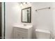 Bathroom with a single sink vanity, framed mirror, and a toilet at 836 S Pasadena St, Mesa, AZ 85210