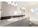 Bright bathroom features dual sinks, gray cabinets, and modern fixtures at 836 S Pasadena St, Mesa, AZ 85210