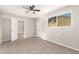 Neutral bedroom with a ceiling fan, plush carpet, and view to the next room at 836 S Pasadena St, Mesa, AZ 85210