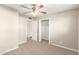 This carpeted bedroom features a ceiling fan, closet and entry to other rooms at 836 S Pasadena St, Mesa, AZ 85210