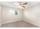 Cozy bedroom featuring carpet, a ceiling fan and a window at 836 S Pasadena St, Mesa, AZ 85210