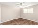 Bedroom with vinyl wood floors, ceiling fan, and a bright window at 836 S Pasadena St, Mesa, AZ 85210