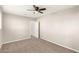 Neutral bedroom featuring a ceiling fan, plush carpet, and view of an attached space at 836 S Pasadena St, Mesa, AZ 85210