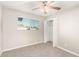 Bright bedroom with plush carpet, ceiling fan, and closet at 836 S Pasadena St, Mesa, AZ 85210