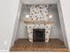 Close-up of the living room's eye-catching stone fireplace with retro design and decorative lighting at 836 S Pasadena St, Mesa, AZ 85210