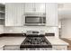 Close-up of the modern gas range and microwave in the updated gray kitchen at 836 S Pasadena St, Mesa, AZ 85210