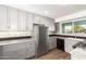 Gray kitchen with stainless steel appliances, ample cabinet space, and wood-look floors at 836 S Pasadena St, Mesa, AZ 85210