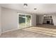 Bright living room boasts tile floors, a stone fireplace, and sliding glass doors to the patio at 836 S Pasadena St, Mesa, AZ 85210