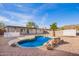 Backyard pool with palm tree and desert landscaping at 9134 E Gary Ln, Mesa, AZ 85207