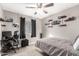 Bedroom with neutral walls, carpet, ceiling fan, and window with dark curtains at 9134 E Gary Ln, Mesa, AZ 85207