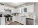 Bright kitchen showcasing quartz countertops, stainless steel appliances, and ample cabinet space at 9134 E Gary Ln, Mesa, AZ 85207