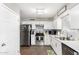 Well-lit kitchen boasting stainless steel appliances, quartz countertops, and white cabinets at 9134 E Gary Ln, Mesa, AZ 85207