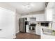 Well-lit kitchen boasting stainless steel appliances, quartz countertops, and white cabinets at 9134 E Gary Ln, Mesa, AZ 85207