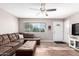 Cozy living room with a large window, modern ceiling fan, and stylish furnishings at 9134 E Gary Ln, Mesa, AZ 85207