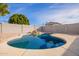 Inviting pool with rock features, surrounded by a block wall for privacy at 9134 E Gary Ln, Mesa, AZ 85207