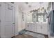 Bright bathroom features a glass shower, double sink vanity, and pendant lighting, as well as tile flooring at 9341 W Willow Bend Ln, Phoenix, AZ 85037