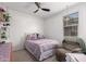 Inviting bedroom with a lilac bed, plush armchair, and decorative shelving for a comforting retreat at 9341 W Willow Bend Ln, Phoenix, AZ 85037