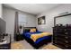 Cozy secondary bedroom features a neutral color palette, window with blinds, and closet access at 9341 W Willow Bend Ln, Phoenix, AZ 85037