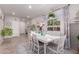 Bright dining room with a white table, decorative accents, and a large window at 9341 W Willow Bend Ln, Phoenix, AZ 85037