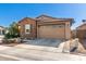 Cozy home with brick facade, a two-car garage and manicured landscaping at 9341 W Willow Bend Ln, Phoenix, AZ 85037