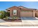 Inviting single-story home featuring a two-car garage, brick accents, and tidy landscaping at 9341 W Willow Bend Ln, Phoenix, AZ 85037