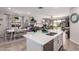 Open concept kitchen flows into dining area with a center island featuring stainless steel sink and a stainless steel dishwasher at 9341 W Willow Bend Ln, Phoenix, AZ 85037