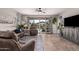 Bright living room featuring tile floors, neutral walls, and a sliding glass door to the patio at 9341 W Willow Bend Ln, Phoenix, AZ 85037